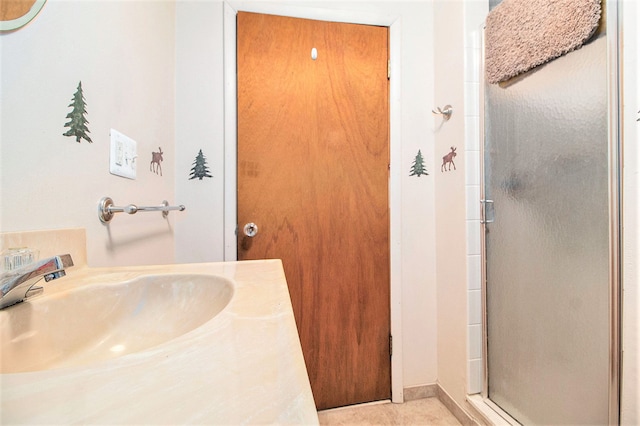 bathroom featuring a shower stall, tile patterned flooring, and vanity