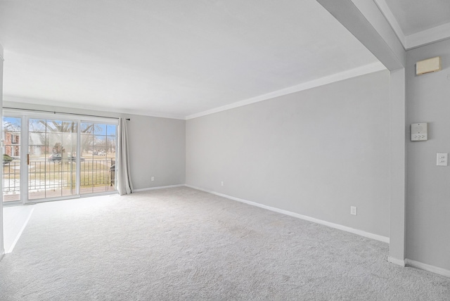 carpeted empty room with baseboards and crown molding