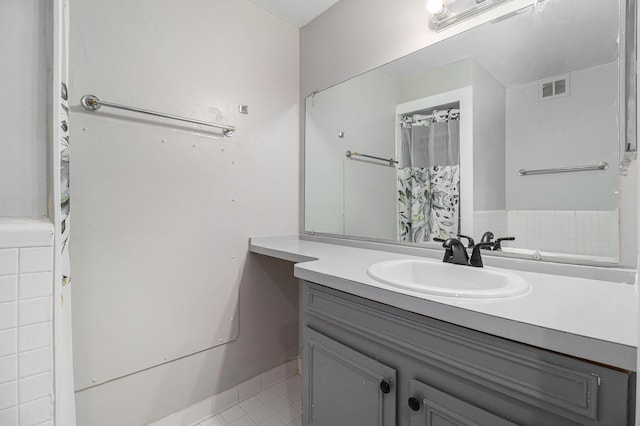 full bath featuring vanity, visible vents, and tile patterned flooring