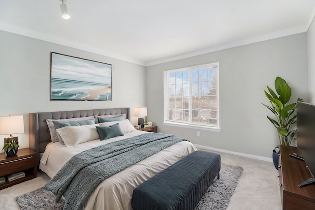 bedroom with baseboards, light carpet, and ornamental molding