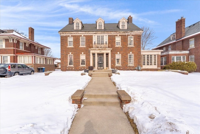 colonial house featuring brick siding