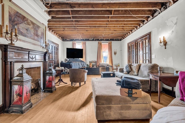 living area featuring a fireplace and wood finished floors