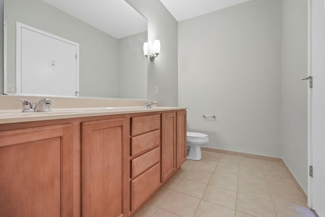 full bathroom featuring double vanity, a sink, toilet, and tile patterned floors