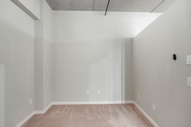 interior space with light carpet and baseboards