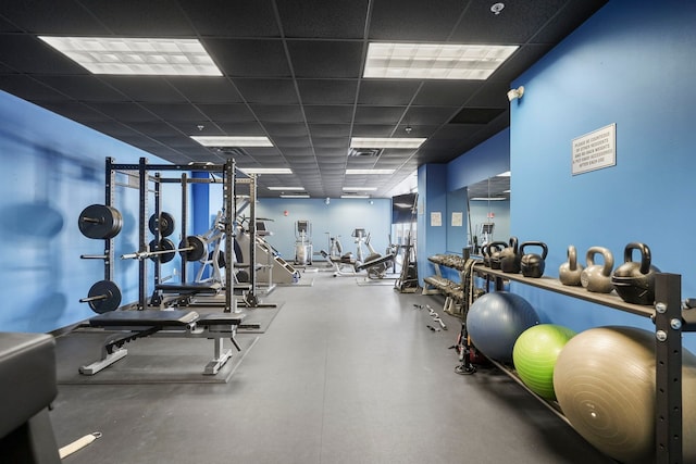 workout area featuring a paneled ceiling