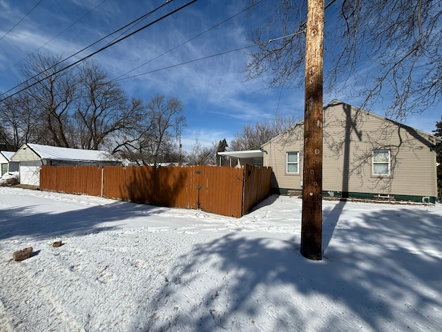 yard covered in snow with fence