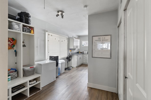 interior space with wood finished floors and baseboards