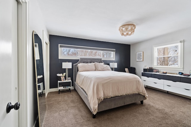 carpeted bedroom featuring baseboards