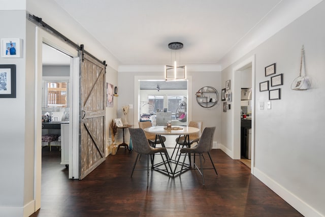 dining room with plenty of natural light, dark wood finished floors, and a barn door