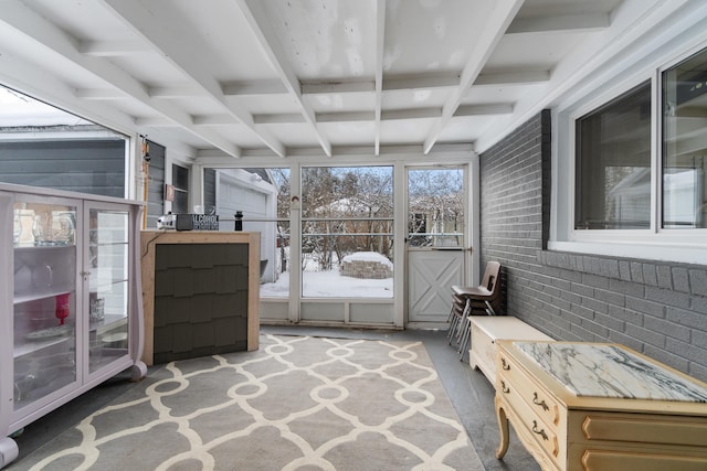 unfurnished sunroom with beam ceiling