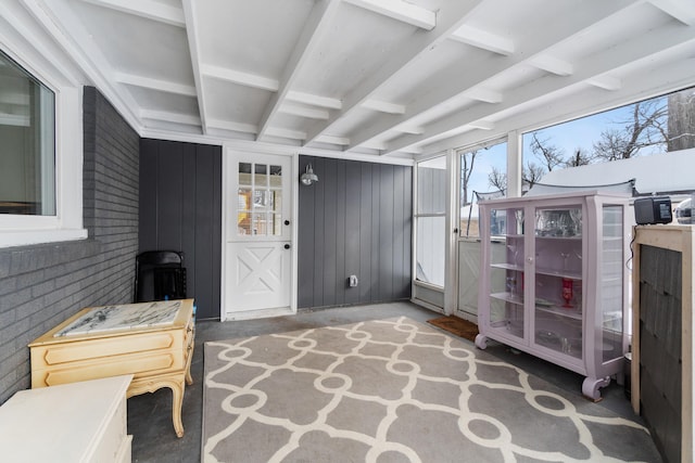 sunroom featuring beamed ceiling