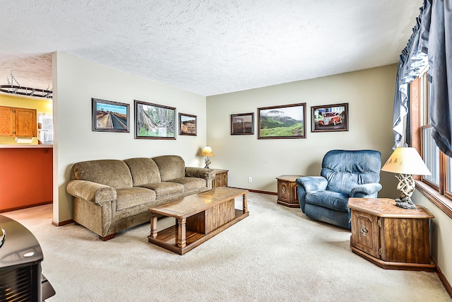 living area featuring baseboards, a textured ceiling, and light colored carpet