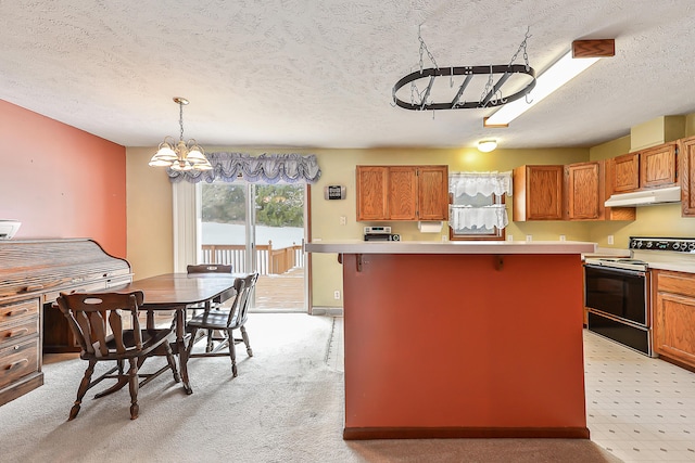 kitchen with a center island, light countertops, range with electric cooktop, under cabinet range hood, and a kitchen breakfast bar