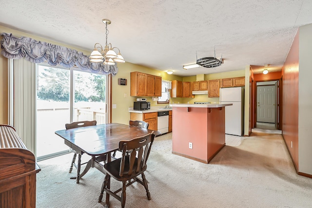 dining space featuring a textured ceiling, light carpet, a chandelier, and baseboards