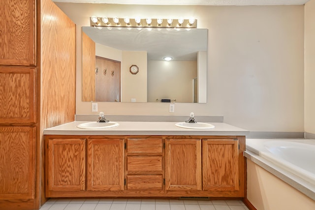 full bath featuring a sink, double vanity, and a garden tub