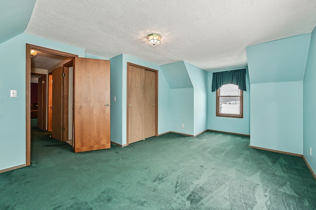 bonus room with carpet floors, lofted ceiling, a textured ceiling, and baseboards