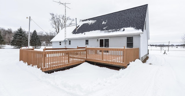 snow covered rear of property featuring a wooden deck