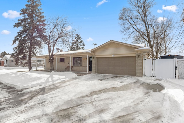 single story home featuring a gate, brick siding, and an attached garage