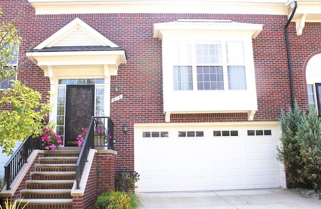 view of front of home with concrete driveway and brick siding