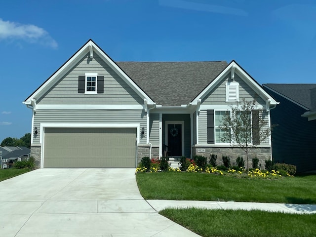 view of front of home with stone siding, a front lawn, and concrete driveway