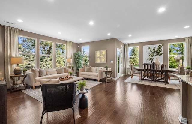 living room featuring baseboards, wood finished floors, and recessed lighting