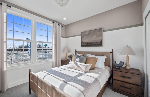 carpeted bedroom featuring baseboards and recessed lighting