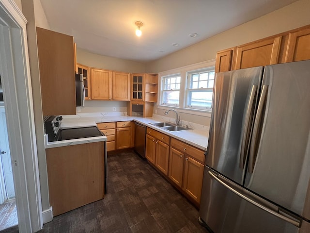 kitchen featuring glass insert cabinets, appliances with stainless steel finishes, dark wood-style flooring, light countertops, and a sink