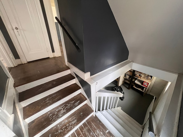 stairs featuring wood finished floors