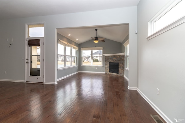 unfurnished living room with lofted ceiling, dark wood-style flooring, visible vents, and a fireplace