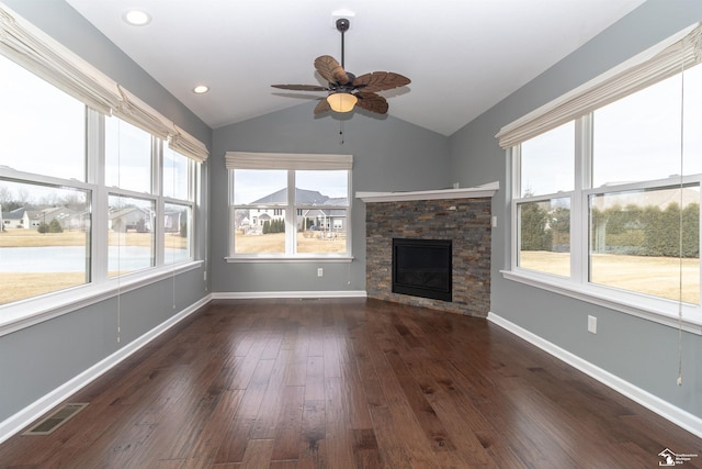 unfurnished living room with baseboards, visible vents, lofted ceiling, wood finished floors, and a fireplace