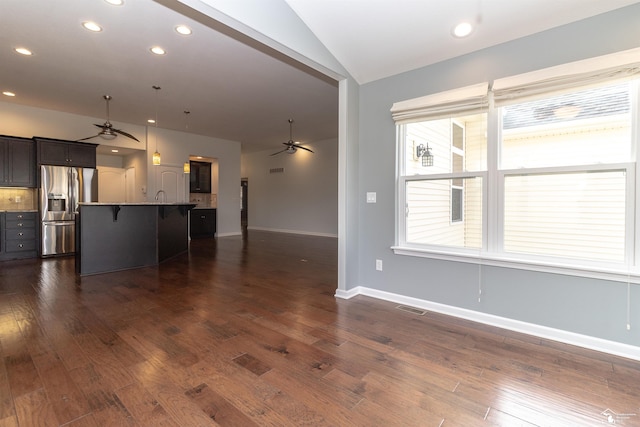 unfurnished living room featuring a ceiling fan, lofted ceiling, dark wood-style flooring, and visible vents