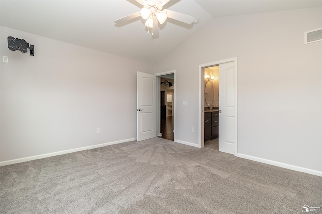 unfurnished bedroom featuring lofted ceiling, light colored carpet, visible vents, and baseboards