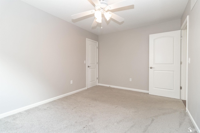 unfurnished room with carpet, baseboards, and a ceiling fan