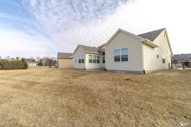 rear view of house with a yard