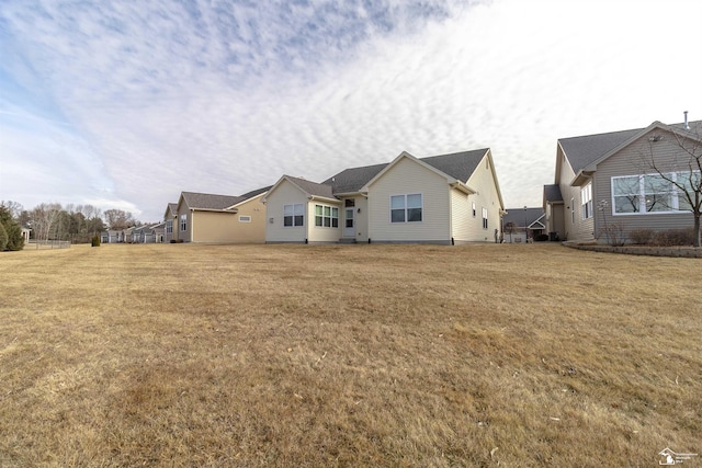 back of house with a yard