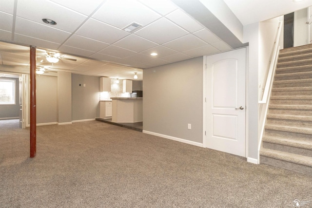 below grade area with baseboards, stairway, and carpet flooring