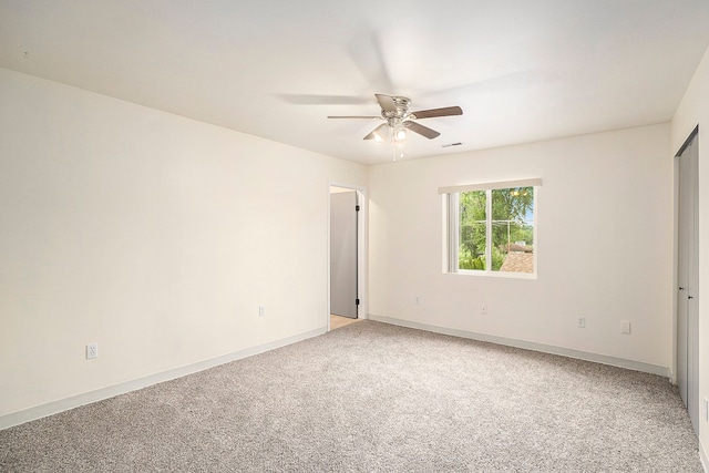 unfurnished room with baseboards, visible vents, a ceiling fan, and light colored carpet