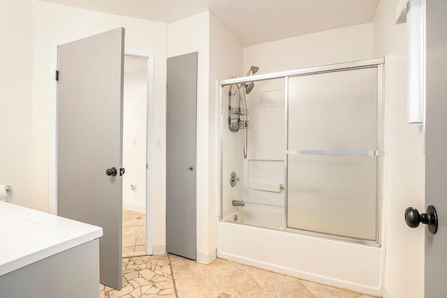 full bathroom featuring tile patterned floors, enclosed tub / shower combo, and vanity