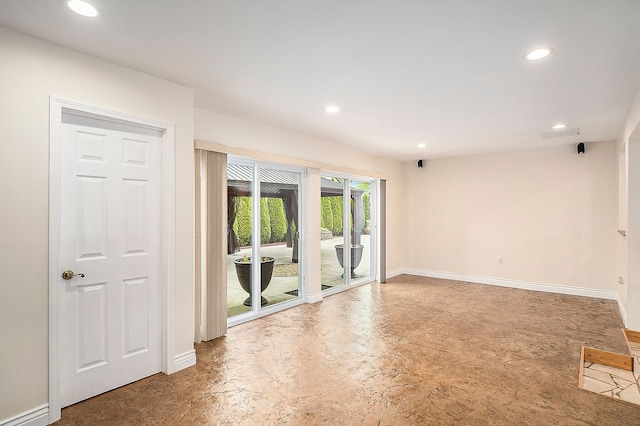 empty room featuring recessed lighting, concrete floors, and baseboards