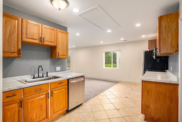 kitchen featuring baseboards, a sink, light countertops, stainless steel dishwasher, and recessed lighting