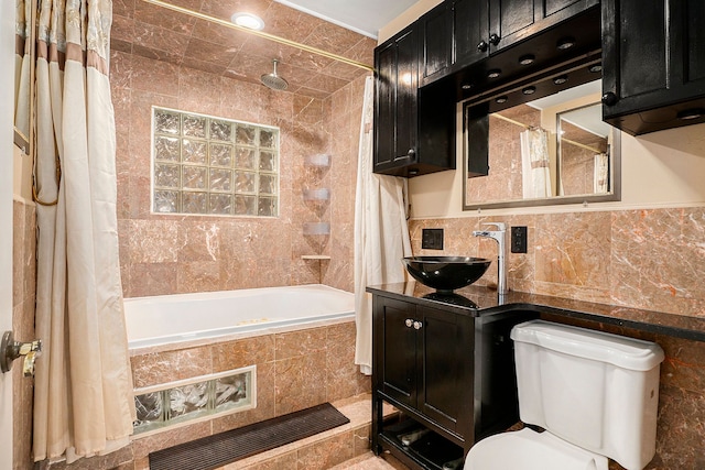 bathroom with toilet, tiled shower / bath combo, visible vents, tile walls, and decorative backsplash