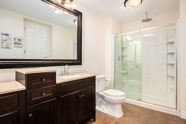 full bath with a stall shower, vanity, and toilet