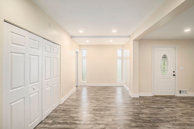 foyer with baseboards, wood finished floors, and recessed lighting