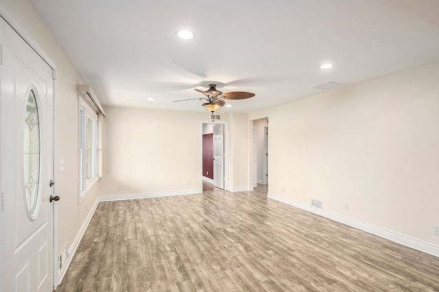 empty room with light wood-style floors, recessed lighting, visible vents, and baseboards