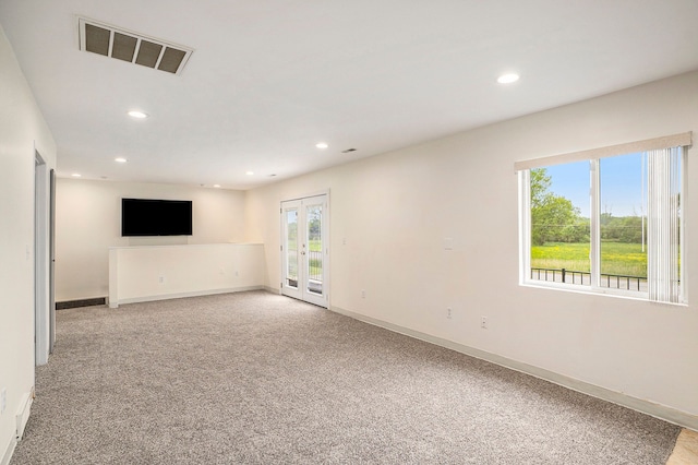 unfurnished room featuring french doors, recessed lighting, light colored carpet, visible vents, and baseboards