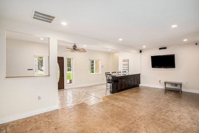 living area featuring recessed lighting, visible vents, and baseboards