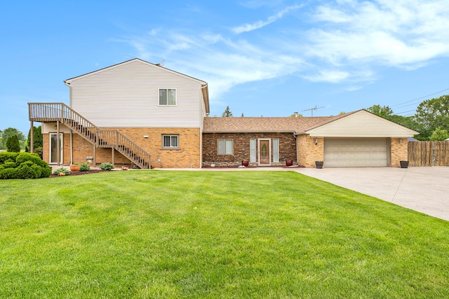 view of front facade with brick siding, an attached garage, and a front yard