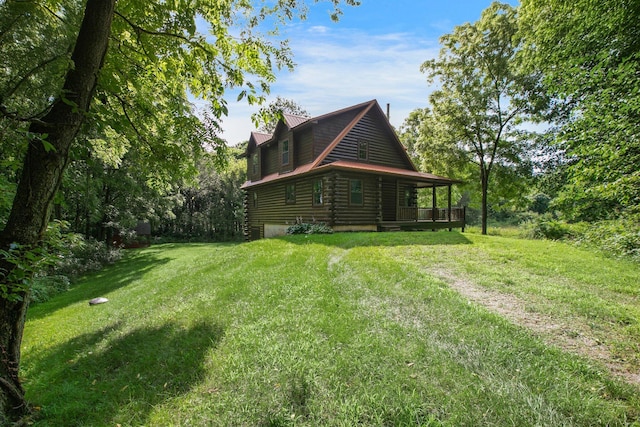 view of home's exterior featuring metal roof, a yard, and log exterior