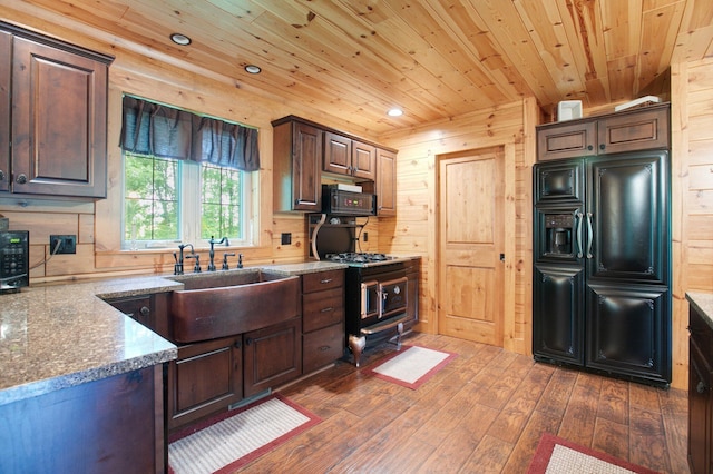 kitchen featuring wooden ceiling, dark wood-style flooring, light stone countertops, black appliances, and a sink