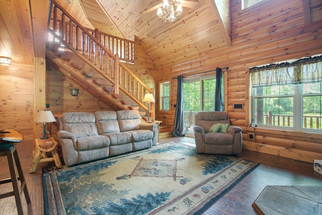 living room with high vaulted ceiling, wood finished floors, wood ceiling, stairs, and rustic walls